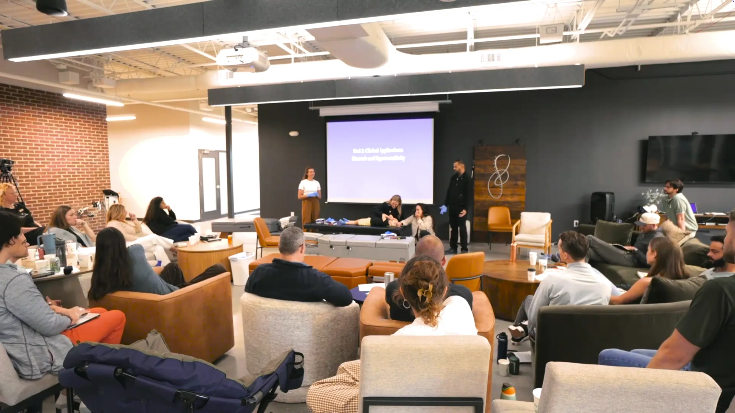 Practitioners gathered for the Floor Four training at Infinity while Dr. Neel Bulchandani teaches a live demonstration